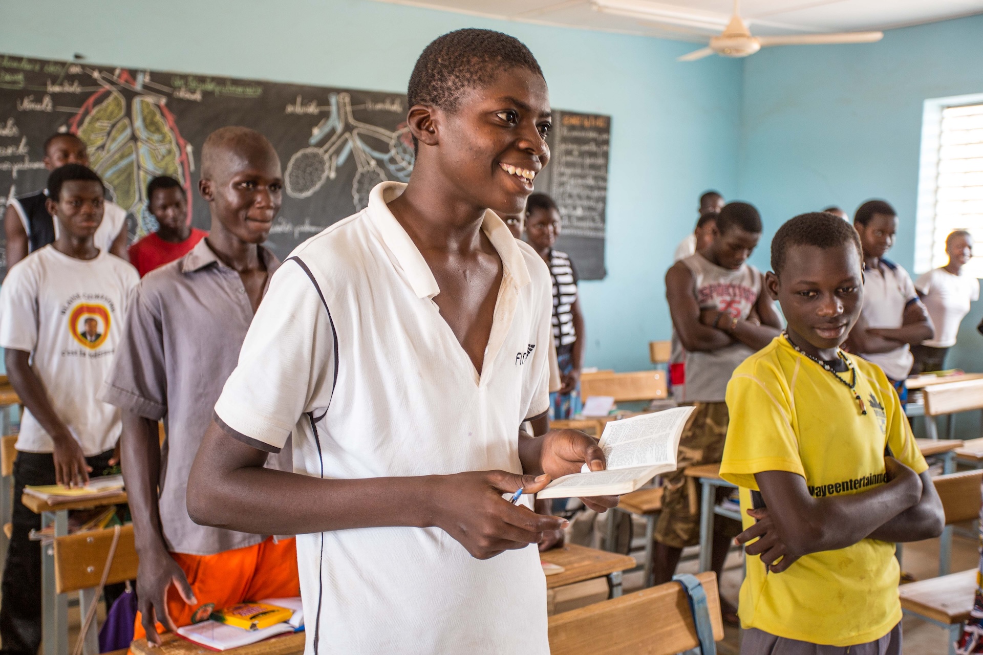 student in Burkina Faso smiling in classroom